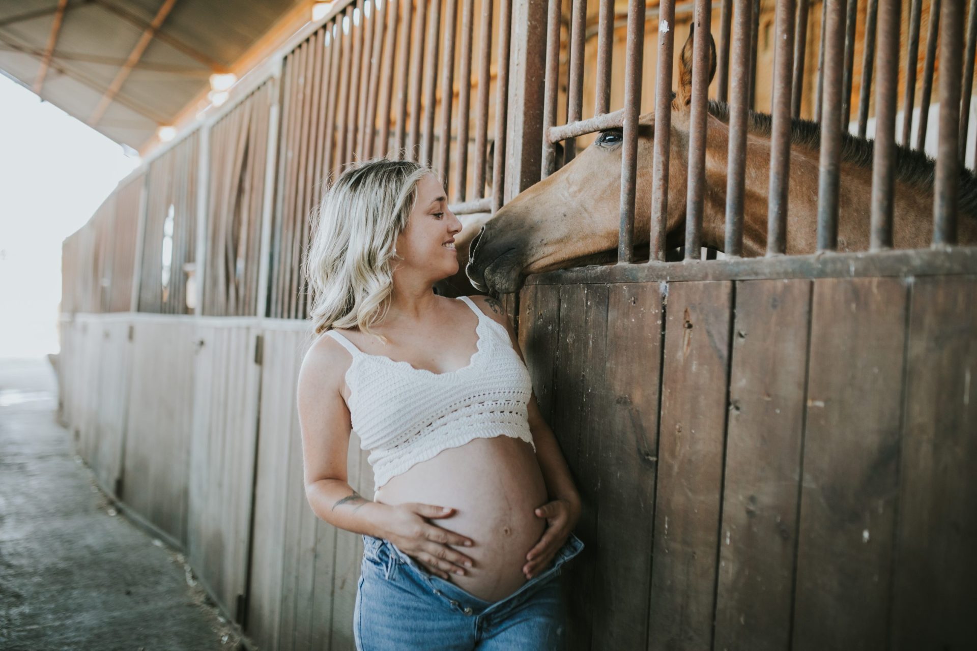 Mujer embarazada observando un caballo
